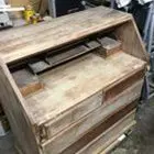 A wooden desk with drawers and shelves in it.