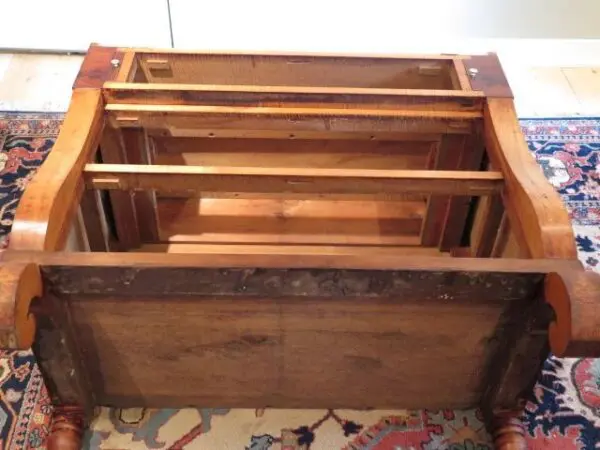 A wooden box with some metal handles on it