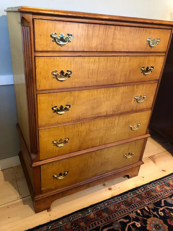 A dresser that is sitting on the floor.