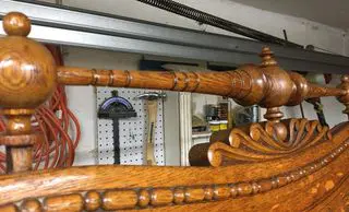 A wooden bench in the middle of a room.